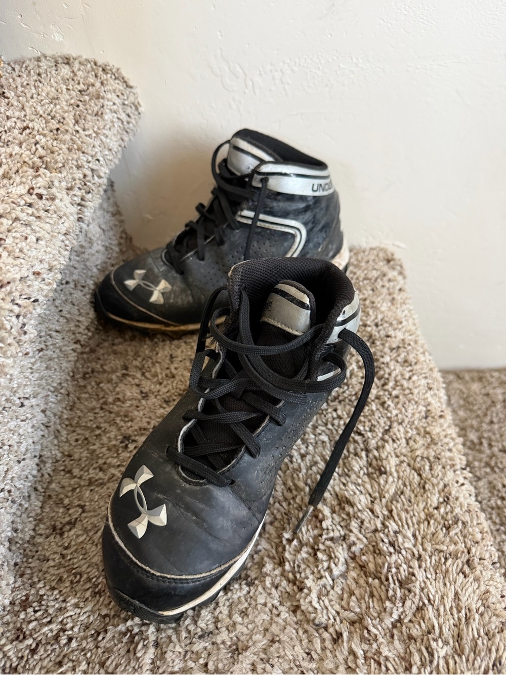 Under Armour youth Black and White Mid-Top football cleats